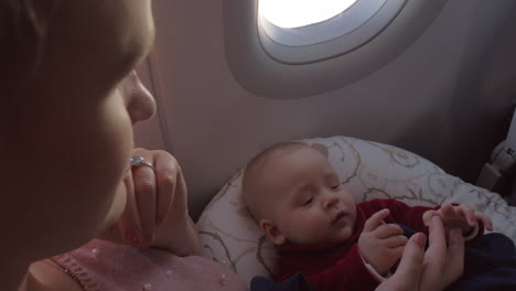 mother and her baby chilling on airplane