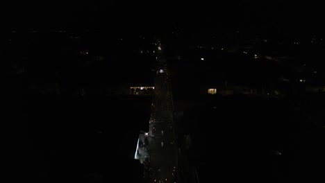 Aerial night footage of El Cerrito Valle del Cauca Colombia during Good Friday showing illuminated streets and religious procession