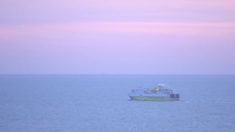 dfds transmanche ferry at sea, purple sky at dusk.