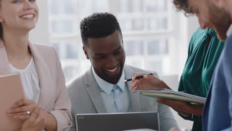 young-african-american-businessman-working-with-creative-team-brainstorming-ideas-enjoying-teamwork-in-office-meeting