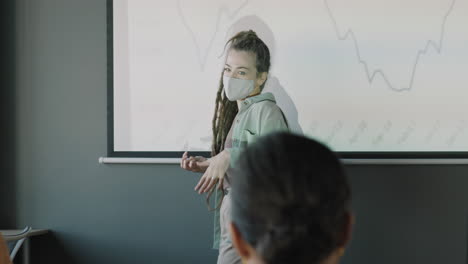 business presentation by woman in mask