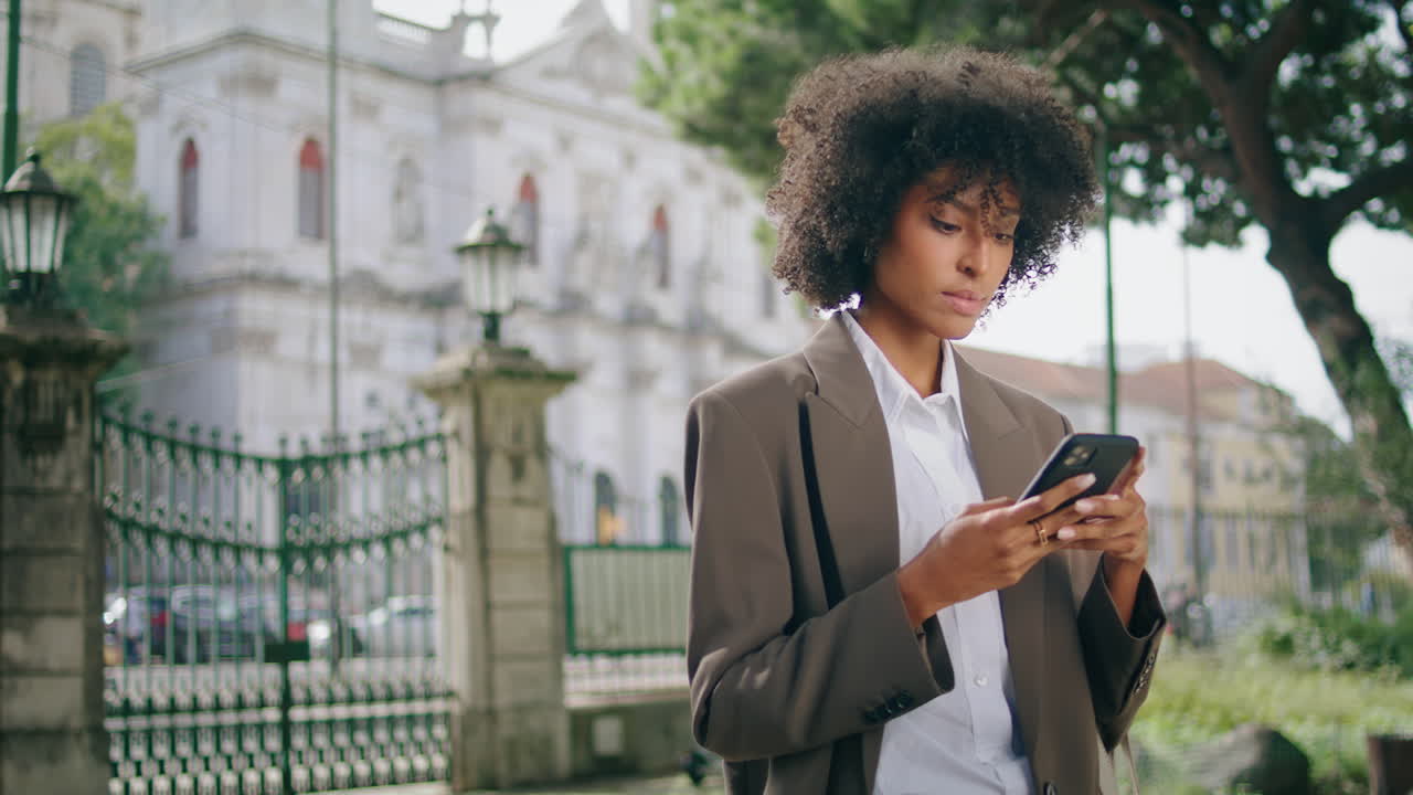 Business woman using smartphone in city park closeup. Girl holding modern mobile