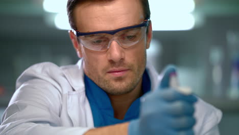 scientist using pipette in laboratory. scientist using dropper