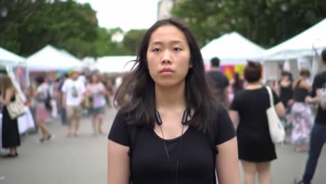 young woman walking through a city market