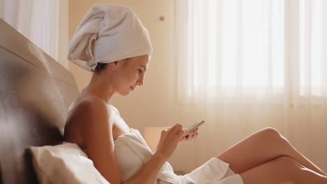 woman using phone in bed, morning relaxation