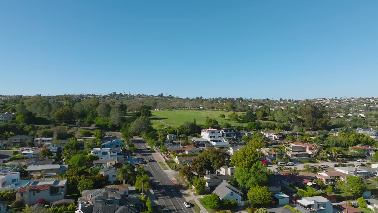 Aerial view of Pacific Beach capturing a vibrant coastal neighborhood view, row of beautiful homes lined along palm tree streets