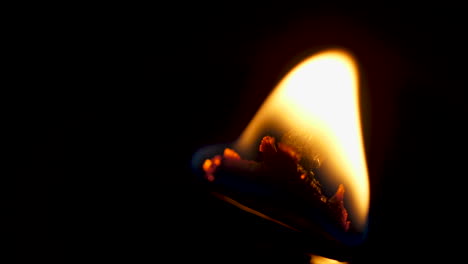 flame on a candle with wood wick macro slow motion