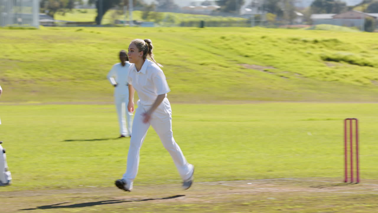 Playing cricket, woman running on field in white uniform during match