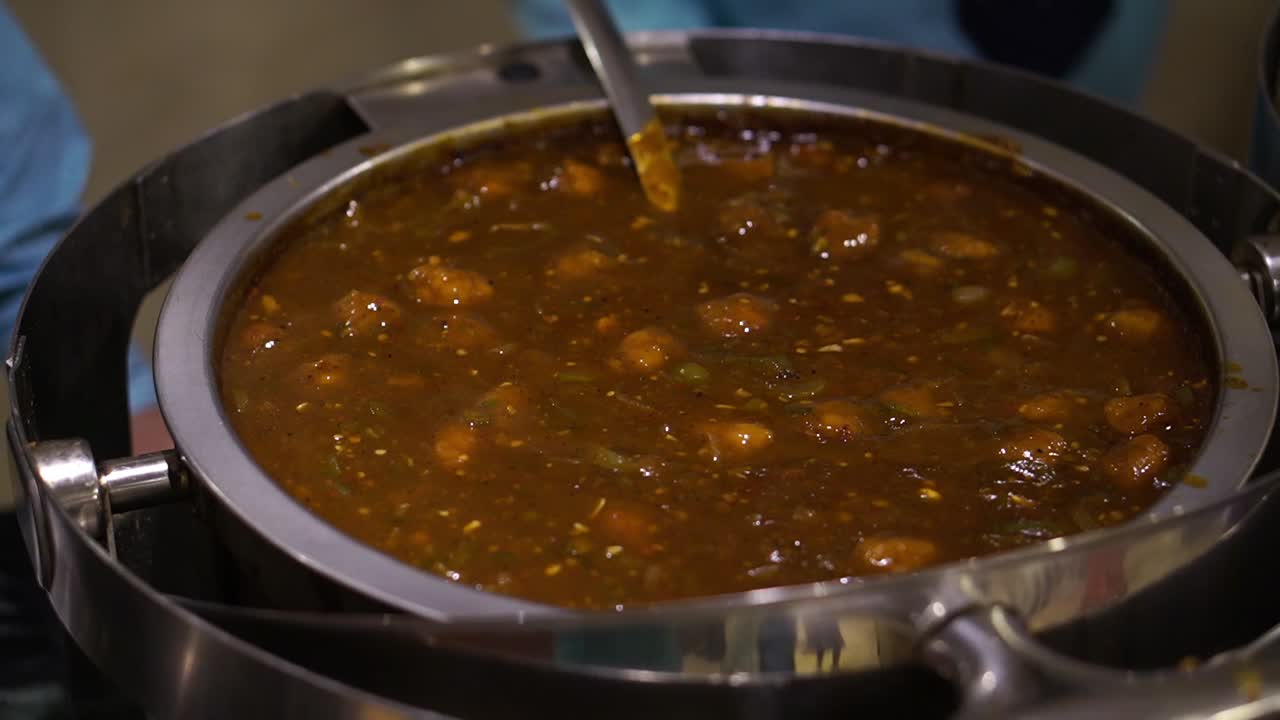 Veg Manchurian dipped in gravy served in wedding. Veg cuisine.
