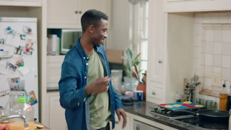 happy-african-american-man-dancing-in-kitchen-having-fun-dance-celebration-enjoying-weekend-at-home