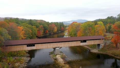 aerial shot of covered bridge in new england during peak foliage in the white mountains of new hampshire