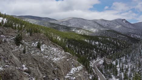 aerial shot reveals expansive landscape with snow covered trees and distant mountains