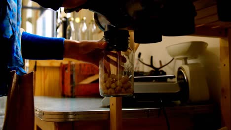 Mid-section-of-woman-taking-snacks-ball-from-vending-machine-4k