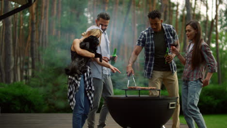 cute woman holding dog on hands outside. relaxed friends spending time in forest