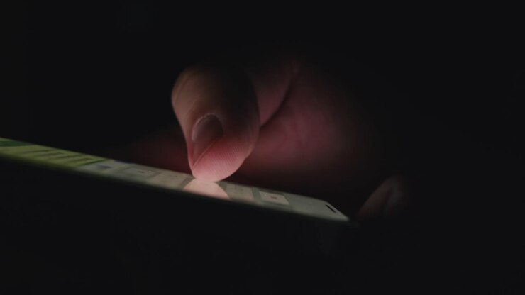 Person using a smartphone at night