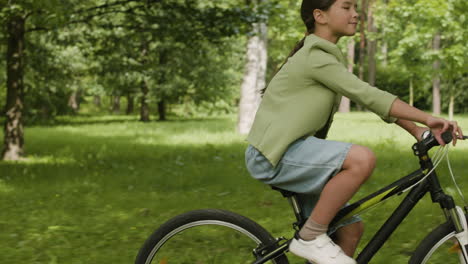 child riding a bicycle in the park