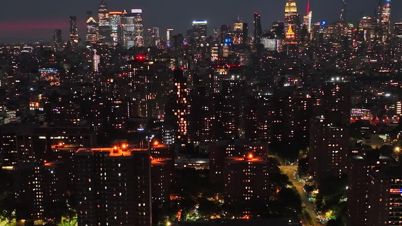 Skyline view of New York City at night from a drone perspective
