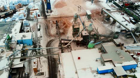 Stunning-aerial-birds-eye-view-shot-of-bustling-plywood-sawmill-in-action