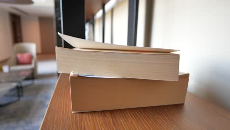 Stack-of-books-in-a-shelf-,