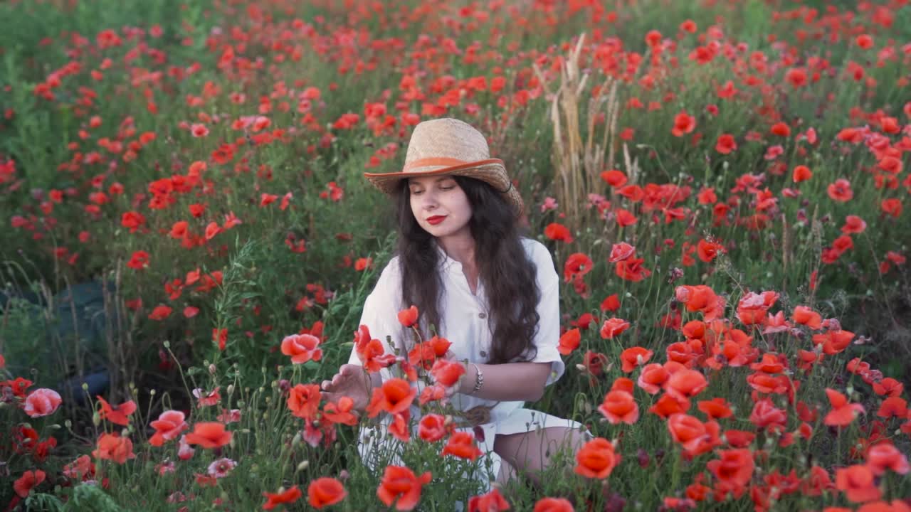 Woman in a Straw Hat Posing in a Vibrant Poppy Field
