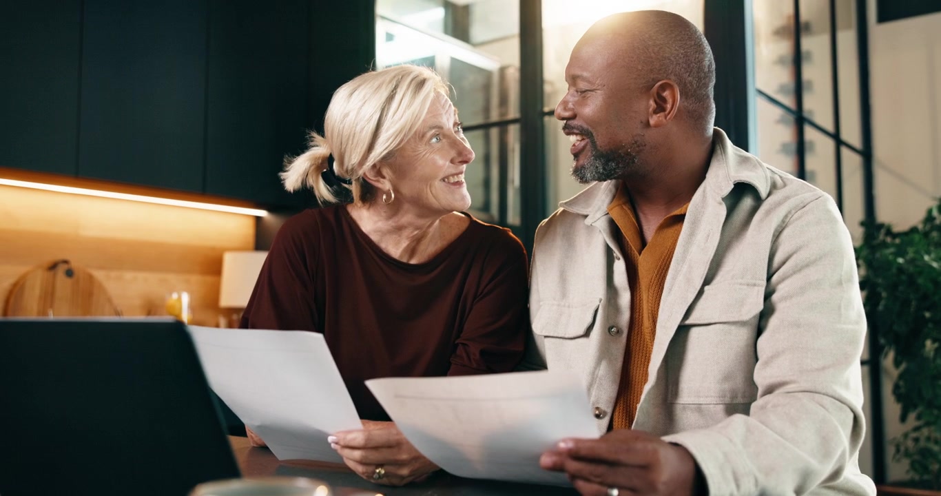 Mature Couple Reviewing Financial Documents Together at Home