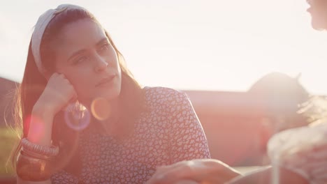 Video-of-two-best-friends-sitting-and-talking-in-the-sun