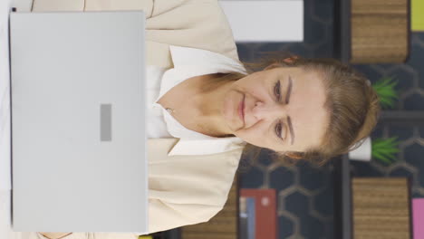 Vertical-video-of-Stressed-business-woman-using-laptop.