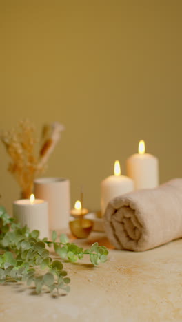 Vertical-Video-Still-Life-Of-Lit-Candles-With-Dried-Grasses-Incense-Stick-And-Soft-Towels-As-Part-Of-Relaxing-Spa-Day-Decor-2