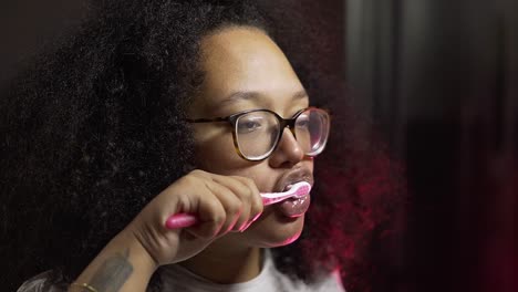 black woman brushing her teeth in slow motion