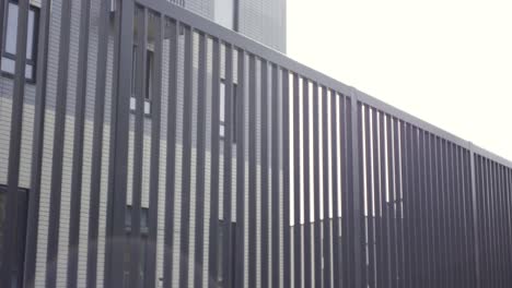 modern apartment building with metal fence