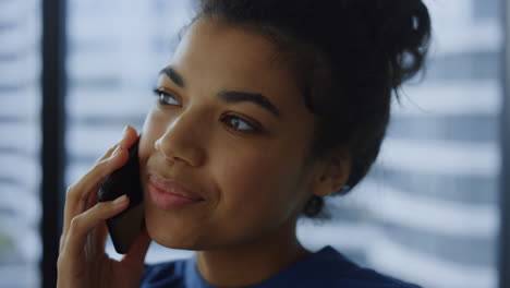 Businesswoman-talking-mobile-phone.-Smiling-corporate-employee-using-cellphone