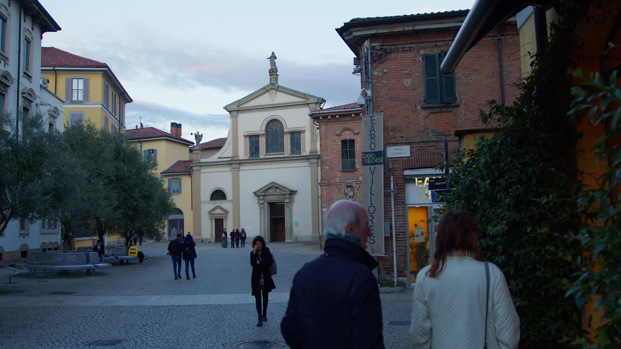 A slow-motion wide shot of a historic theatre and cathedral in Monza under blue moonlight, evoking a cold, mystical autumn atmosphere.