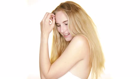 beautiful-young-woman-with-braces-on-seamless-white-studio-background-laughing-and-smiling