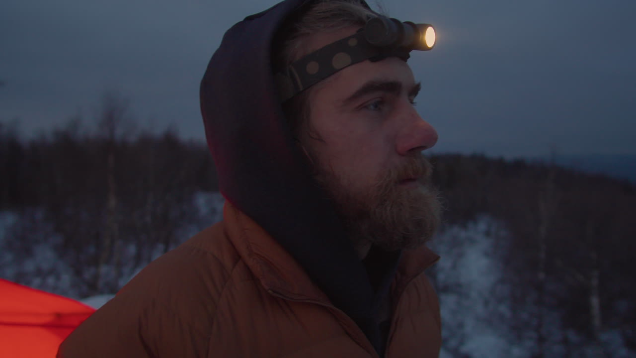 Tourist Drinking Tea at Campsite in WInter