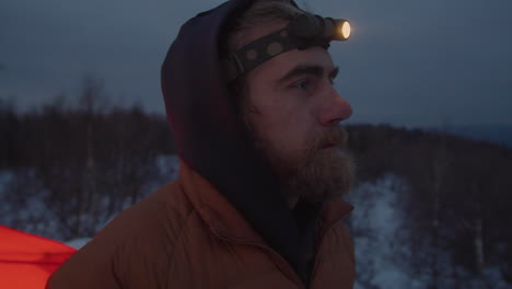 tourist drinking tea at campsite in winter