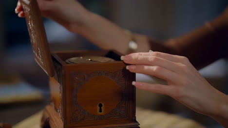 opening an ornate wooden jewelry box