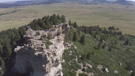 Aerial-views-of-a-grassy-plane-heading-to-a-beautiful-rock-formation-in-Palmer-Lake-Colorado