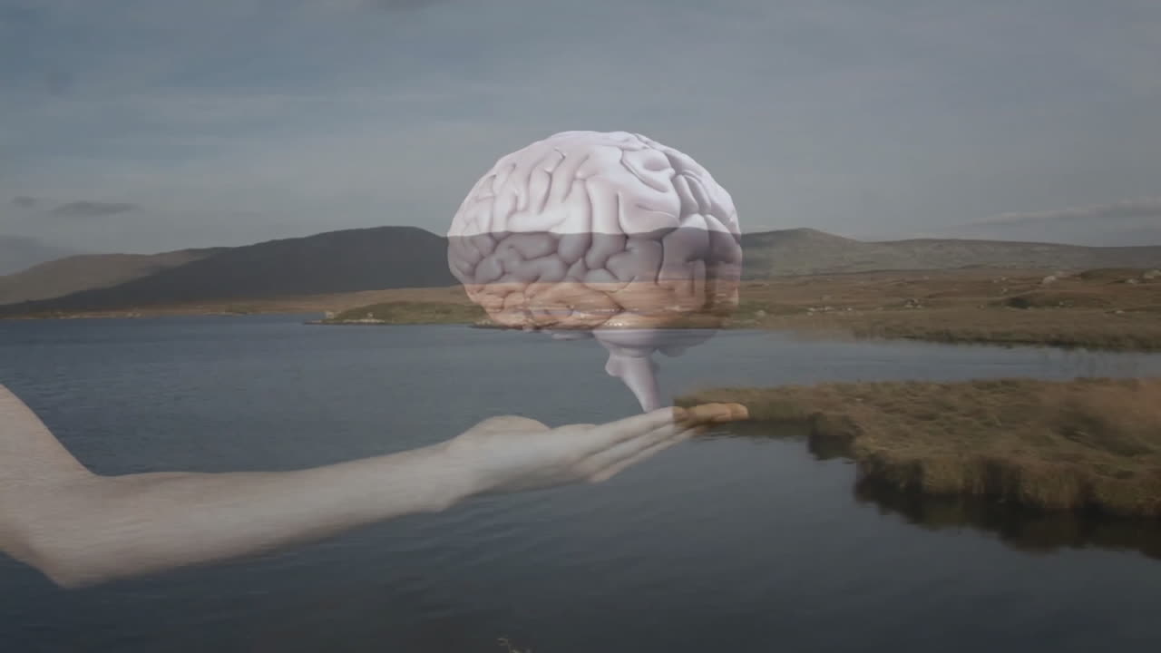 Floating brain animation over hand near serene lake with mountain background