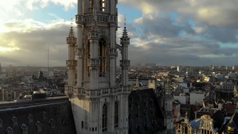 Aerial-upward-flying-of-Grand-Place-Brussels-Town-Hall-on-sunny-and-cloudy-day-in-Brussels,-Belgium