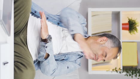 Vertical-video-of-Man-closing-laptop-with-angry-expression.