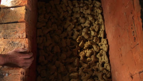 watch traditional animal-figured clay souvenirs being stacked in a wood-heated oven in thanh ha, capturing the essence of local artistry and craftsmanship