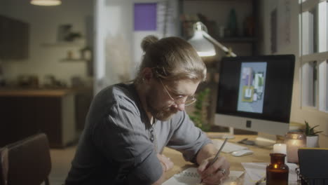 designer drawing in evening at home
