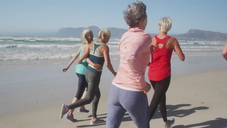 athletic women running on the beach