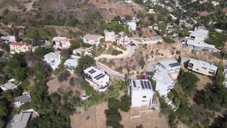 Hollywood-homes-with-solar,-aerial-view-over-mountain-side-houses