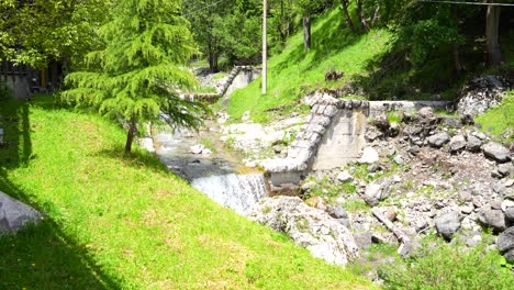 little cascade created by overflow of dam in sottoguda, italy