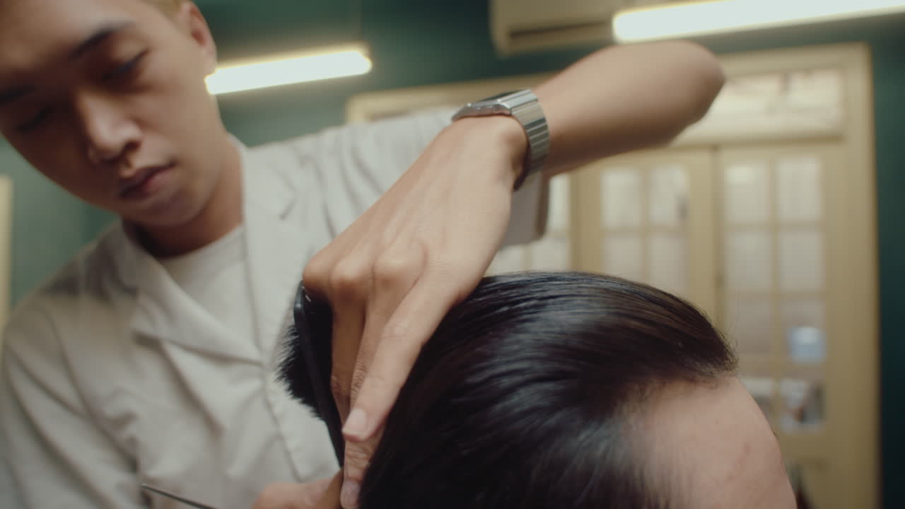 Barber Using Shears and Comb for Giving a Haircut