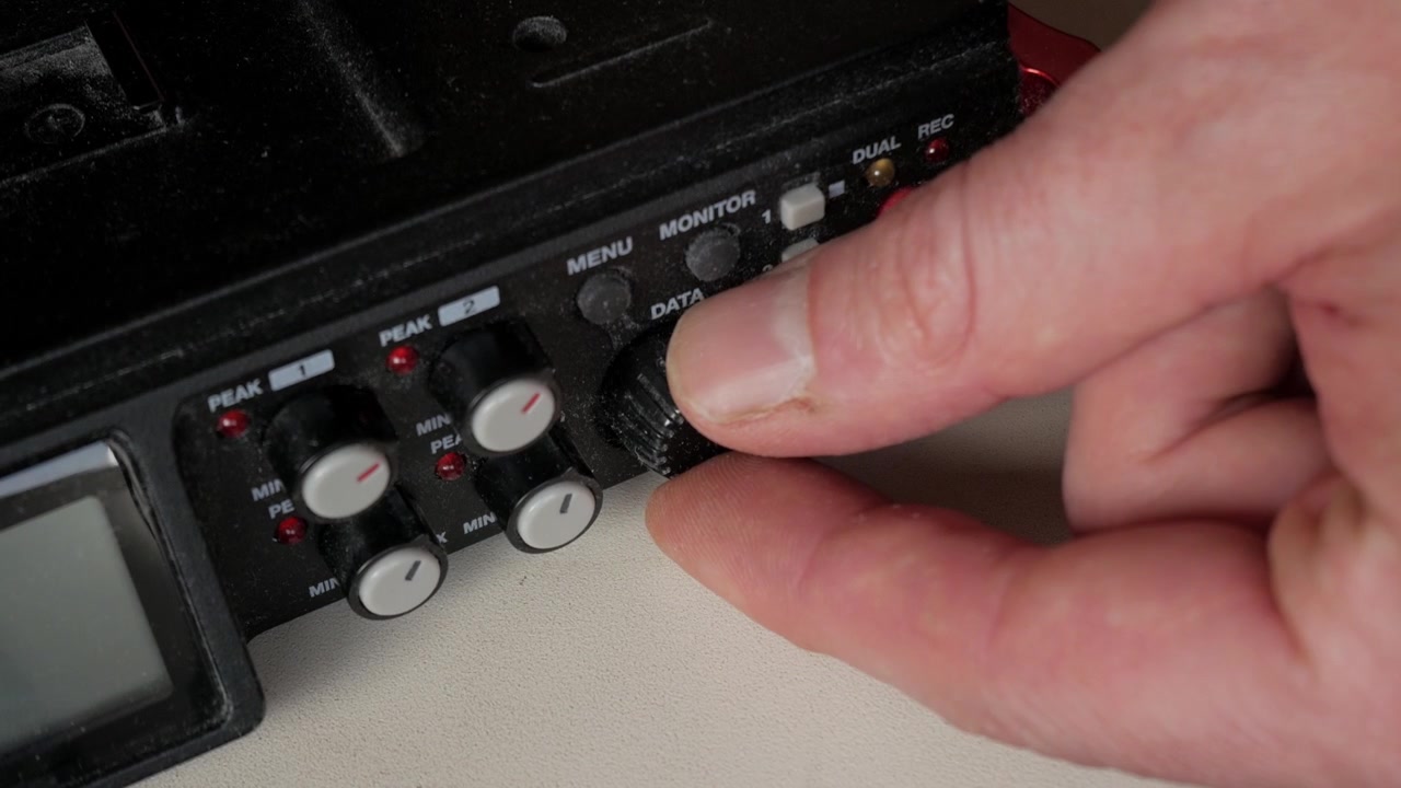 Sound recorder on white table for music production setup.