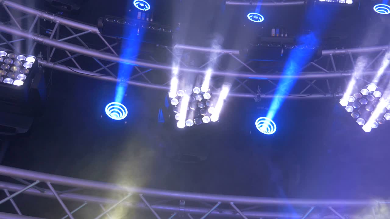 Led Stage Light Shining Different Colors and Spinning From the Rafters