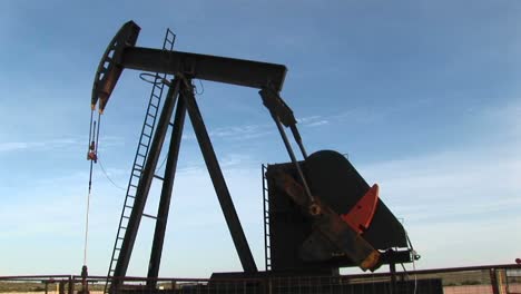 medium shot of an oil pump turning in the new mexico desert 1