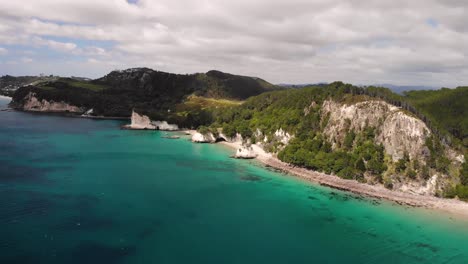 cathedral cove in coromandel peninsula aerial fly backward shot of nice coastal scenery new zealand